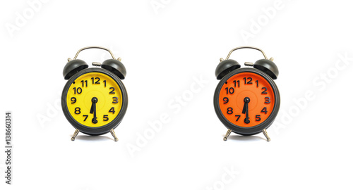 Closeup yellow alarm clock and orange alarm clock for decorate show a half past nine or 9:30 a.m. isolated on white background