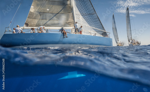 Blue sailing boat on the sea with keel under water