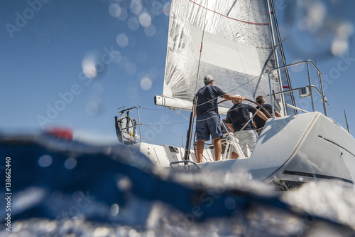 Aft of sailing boat with skipper from underwater view