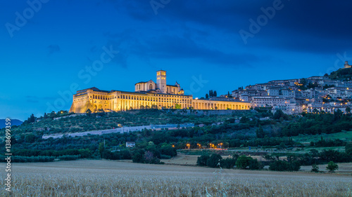 Historic town of Assisi illuminated in twilight, Umbria, Italy