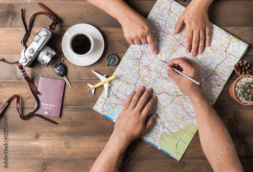 Young couple planning vacation trip with map. Top view.