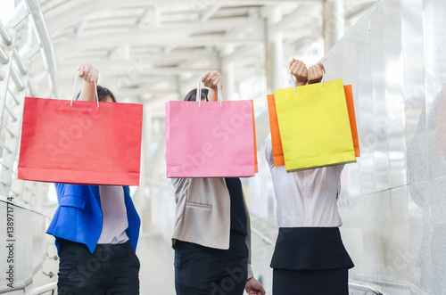 Group of shopping asia women holding up shopping bags.