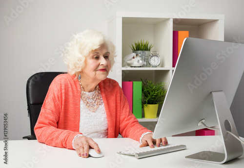 older woman working in the office