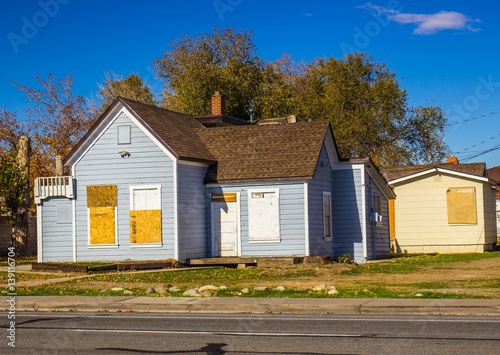 Abandoned Home With Boarded Up Doors & Windows