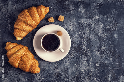 Croissants and coffee on a dark background