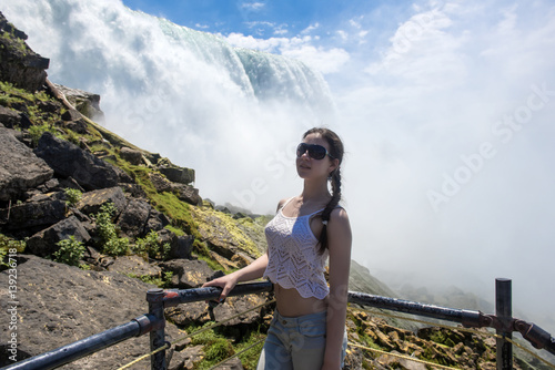 Teenage girl on the background of Niagara Falls