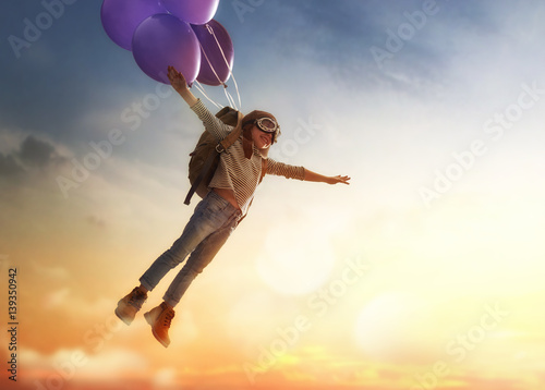 Child flying on balloons