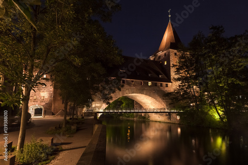 Nuremberg, Germany old town on the Pegnitz River. Castle wall night, night bridge