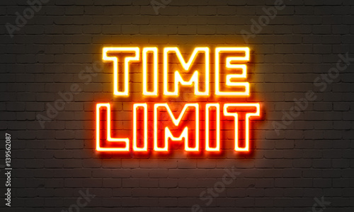 Time limit neon sign on brick wall background.