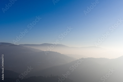 View from Yburg castle in direction mountain Hornisgrinde with fog in the valley