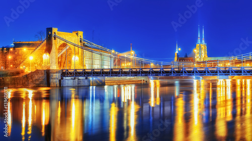 Old Grunwaldzki bridge over Oder river, Wroclaw. Beautiful dramatic Night scenery.