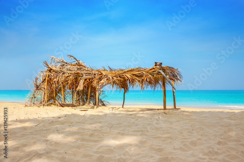 Hovel made of palm leaves on the beach
