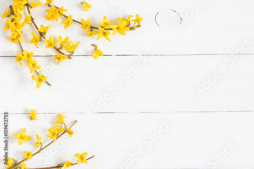 Flowers composition. Frame made of yellow flowers on wooden white background. Easter, spring, summer concept. Flat lay, top view