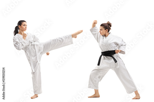 Two young women in kimonos practicing martial arts