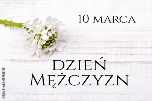 Men's day card with Polish words DZIEŃ MĘŻCZYZN and coffee beans cup on white wooden background
