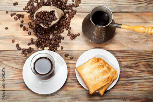 Breakfast, toast and Turkish coffee on a wooden background