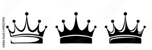 Set of three vector black silhouettes of crowns isolated on a white background.