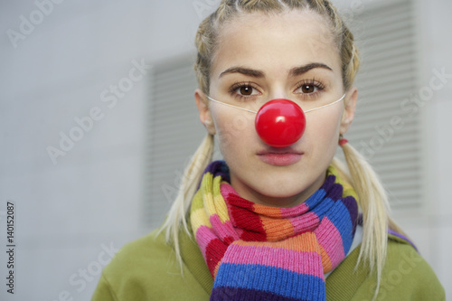 Young woman wearing red nose