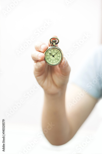 hand holding a vintage pocket clock