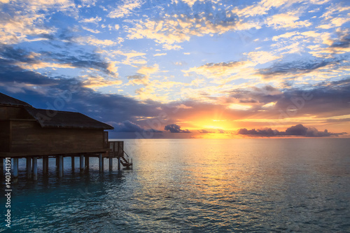 Maldives water villa at sunset
