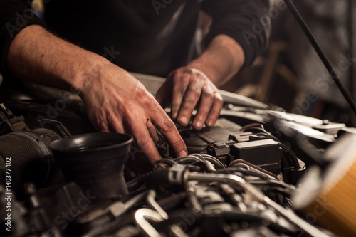 mechanic fixing a car at home