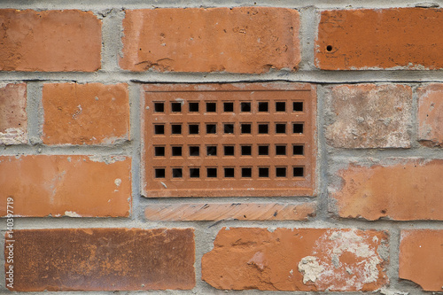 brick wall with a close up showing a ventilation brick