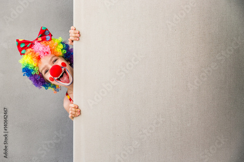 Funny kid clown playing indoor