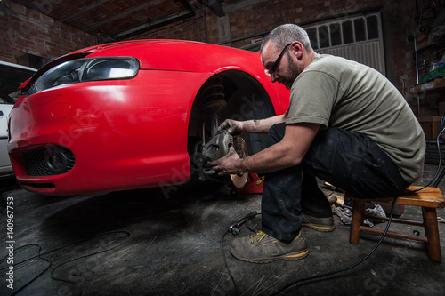 mechanic fixing a car at home