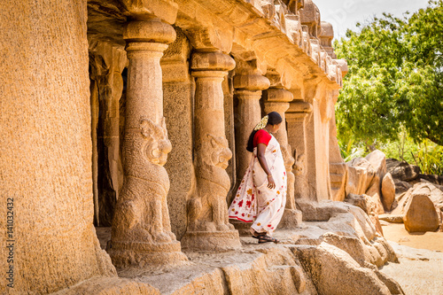 Hindu woman in an ancient monolithic after praying. Pancha Rathas - Five Rathas, Mahabalipuram, Mamallapuram, Tamil Nadu, India