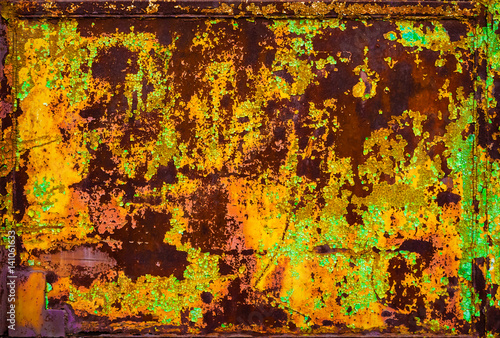 Background of a rusty metal fence with peeling paint.