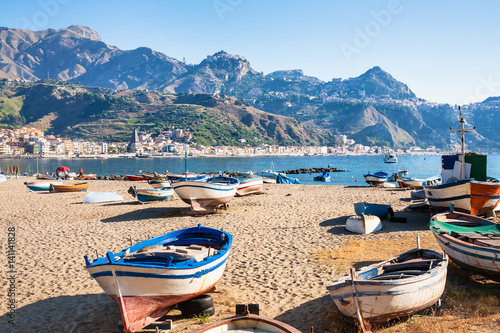 boats on urban beach in giardini naxos town