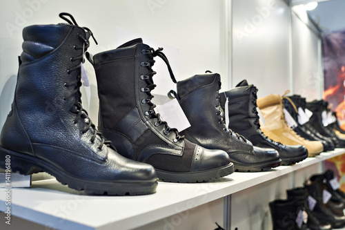 Black leather boots on shelf in store