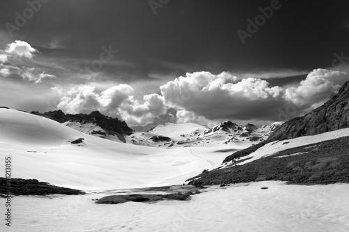 Black and white view on snow plateau with footpath