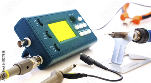 Modern digital signal oscilloscope and tools isolated on white background closeup
