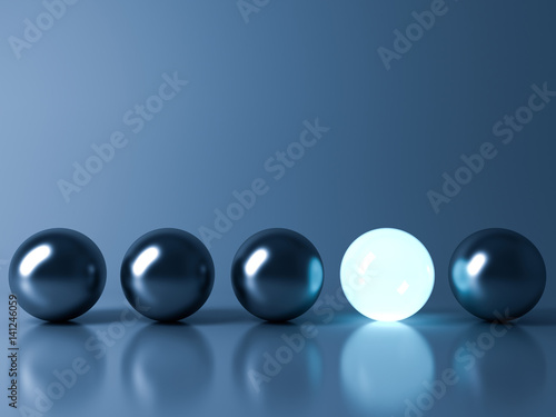 One blue glowing light ball standing out from the metal sphere balls on dark blue background with reflection and shadow , individuality and different creative idea concepts . 3D rendering.