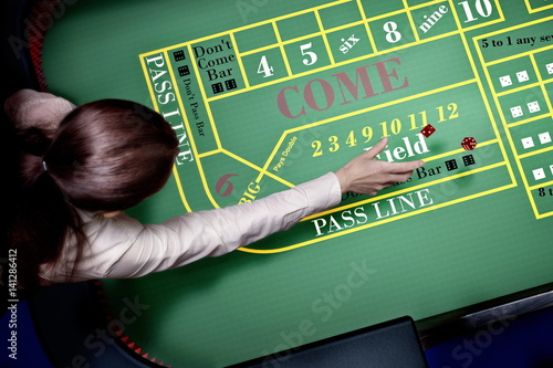 dice throw on craps table at casino