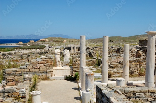 Marble ruins of ancient city/ House ruins of ancient Athenians: Cleopatra and Dioscoride. And remains of a monument to them. Island of Delos, Cyclades, Greece. Near island of Santorini. On tour