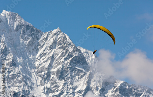 Paraglider flying against the mountain Lhotse (8516 m) - Everest region, Nepal, Himalayas