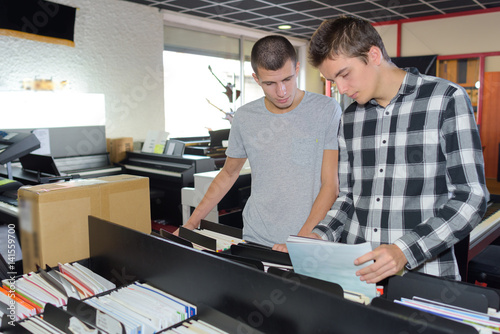 men on a room of folders