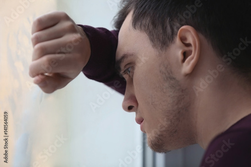 Handsome depressed man at home