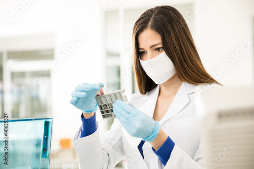 Female chemist analyzing some blood