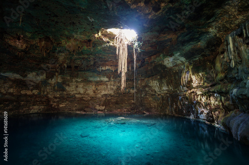 Sunbeams penetrating in opening of Blue cenote