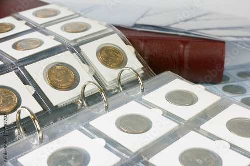 Coins in the album. Selective focus.