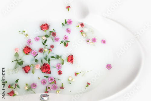 mix flower petals and leaves in milk bath, background or texture for massage and spa, relax 