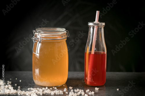 Fermenting water kefir and water kefir ready for drinking.