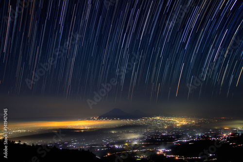 Night island of Java from the slope of Merapi volcano and star track