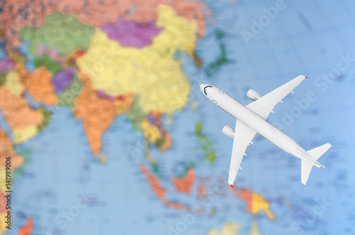 Flight to Asia symbolic image of travel by plane map