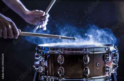 man plays musical percussion instrument with sticks, a musical concept, beautiful lighting on the stage