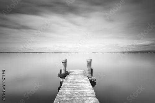 Frozen time. Black and white. Minimalistic landscape on the lake. Long exposure.