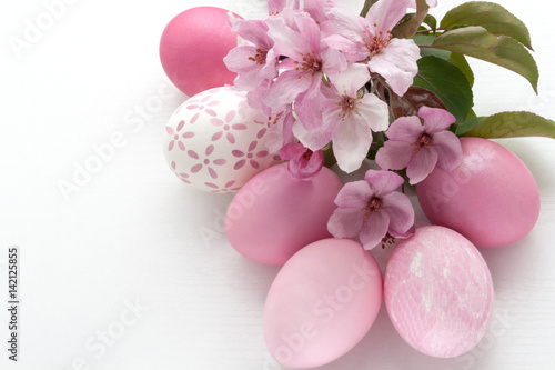 Easter. Greeting Card with pink colored Eggs and apple blossom on a white background. Resurrection Sunday. Pascha.